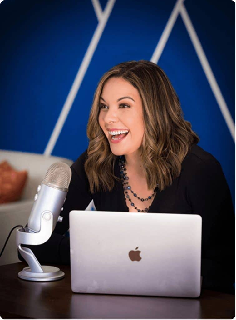 Diana Lowe, executive coach, working on laptop in a professional setting